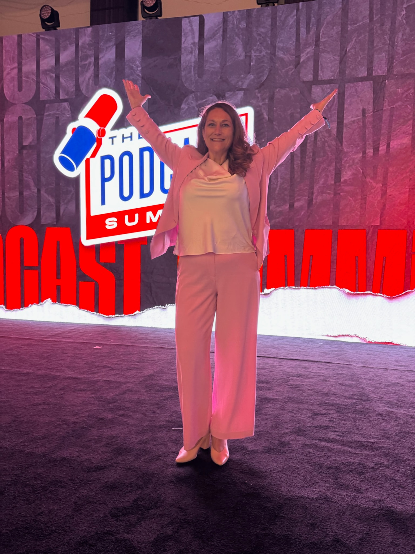 Joy St. John on stage at the Podcast Summit